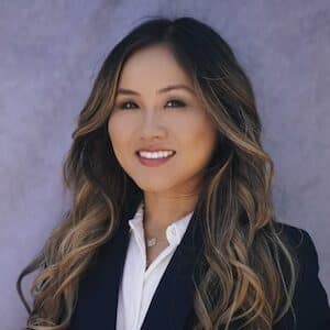 dr tran smiling at camera in professional outfit