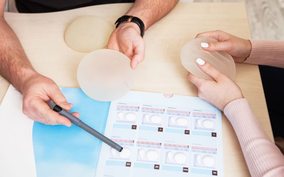 A plastic surgeon doctor shows a sample set of a silicone implants for breast augmentation