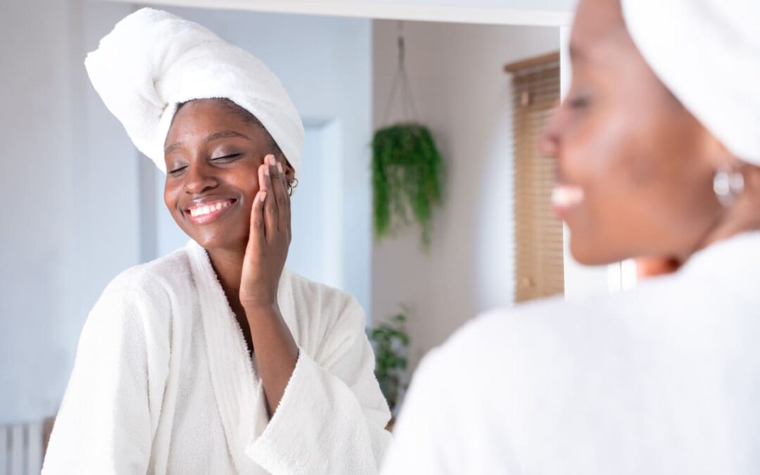 woman admiring clean, healthy skin in mirror