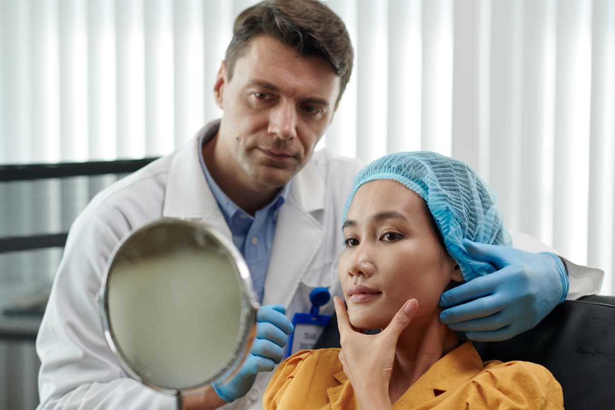 doctor showing patient face in mirror