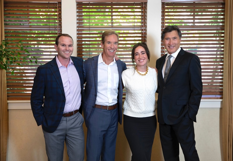 Napa Solano Plastic Surgery team of 4 board-certified plastic surgery doctors smiling in the office.