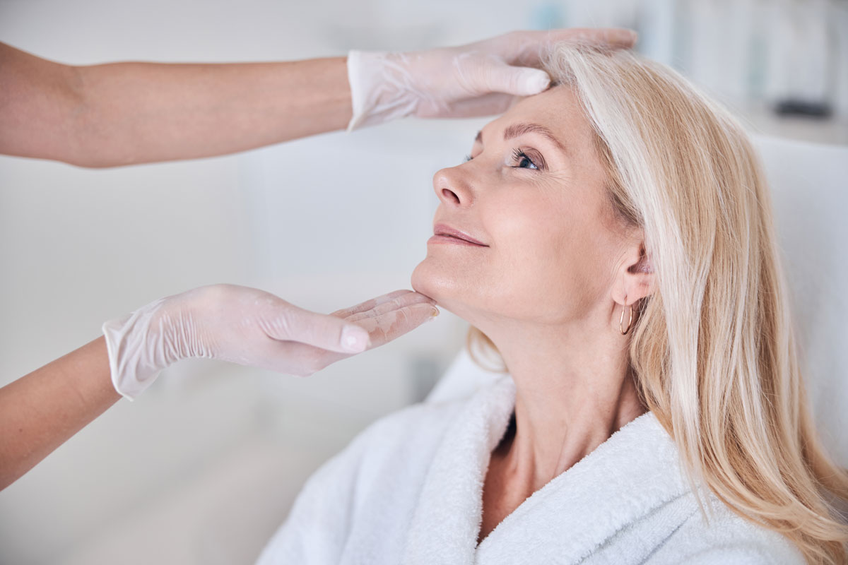 women having someone look at face after facelift