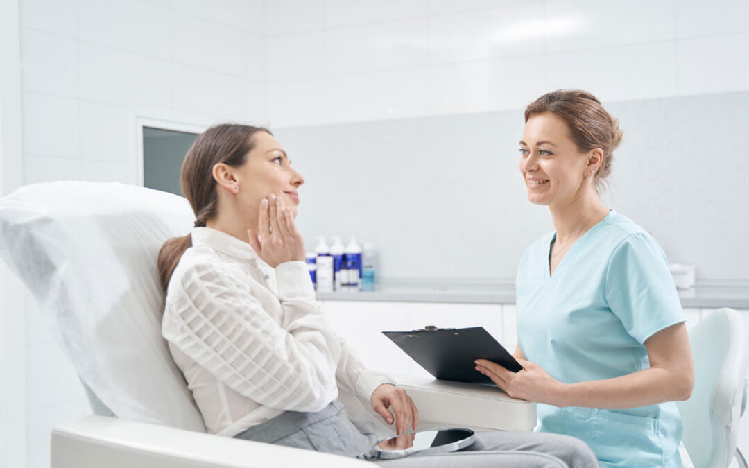 Woman talking with doctor beautician in cosmetology clinic